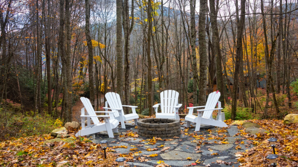 gardening furniture in a garden with fallen yellow leaves autumn decor