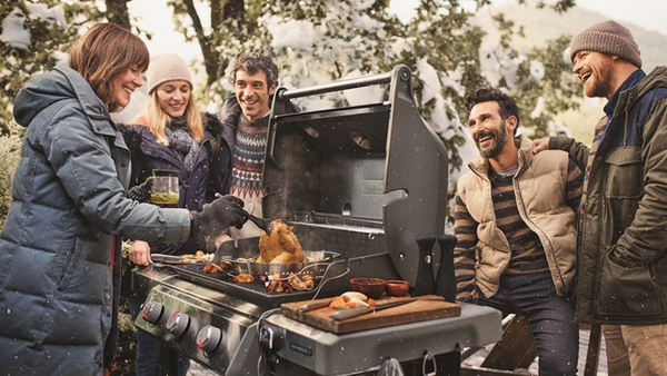 group of friends men and women around the grill 