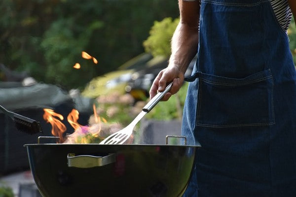 man grilling using a steel spatula