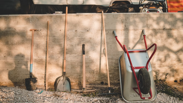 shovel wheelbarrow rack aligned on a wall