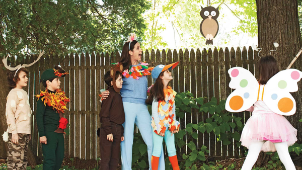 children in various costumes looking on the right side